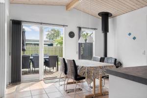 a kitchen and dining room with a table and chairs at 40152-Juelsminde-Mirabellevej-5 in Juelsminde