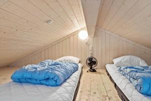 two beds in a room with a ceiling at 30439-Odder-Strandvaenget-74 in Odder