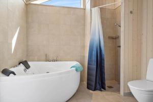 a bathroom with a tub and a shower and a toilet at 30439-Odder-Strandvaenget-74 in Odder +36 photos