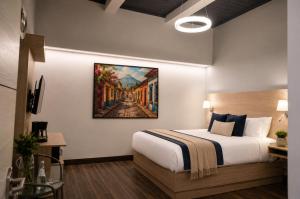 a hotel room with a bed and a painting on the wall at Casa Bella Boutique Hotel in Antigua Guatemala
