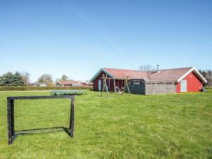 a field with a soccer goal in front of a house at 4 star holiday home in Nordborg in Nordborg