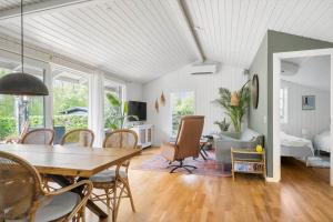 a living room with a table and chairs and a bedroom at 30338-Odder-Skovlunden-11 in Odder