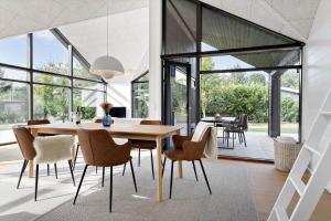 a dining room with a table and chairs at 30315-Odder-Grindevej-22 in Odder