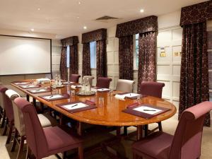 a conference room with a large wooden table and chairs at Mercure Salisbury White Hart Hotel & Apartments in Salisbury
