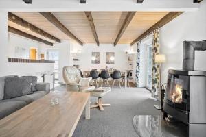 a living room with a couch and a fireplace at 40154-Juelsminde-Nattergalevej-10 in Juelsminde