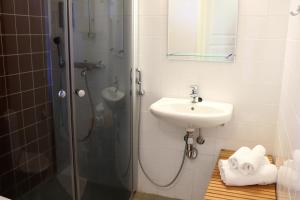 a bathroom with a shower and a sink at Oravi Apartments in Oravi