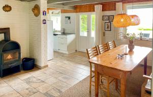 a kitchen and dining room with a table and a stove at Awesome Home In Haderslev With Wifi in Haderslev +11 photos