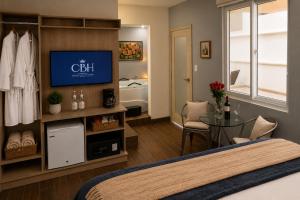 a hotel room with a bed and a flat screen tv at Casa Bella Boutique Hotel in Antigua Guatemala