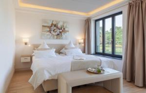 a white bedroom with two beds and a window at Diamond in Binz +46 photos