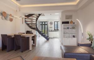 a kitchen and dining room with a spiral staircase in a house at Diamond in Binz