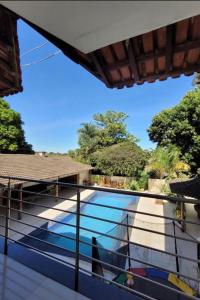 a view of a swimming pool from a balcony at Pousada Recanto do Bosque in Luziânia +3 photos
