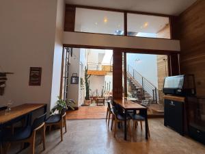a living room with a table and chairs and a balcony at Pampa Hotel Boutique in Iquique