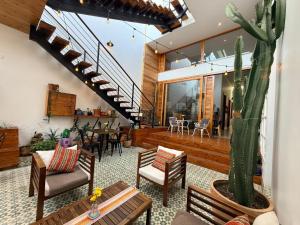 a living room with a staircase and a cactus at Pampa Hotel Boutique in Iquique