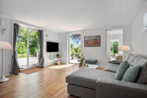 a living room with a couch and a tv at 30490-Saksild-Praesteager-221 in Saksild
