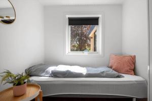 a bed sitting in a room with a window at 30490-Saksild-Praesteager-221 in Saksild