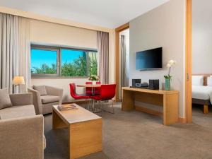 a living room with a couch and a room with a bed at Novotel Gaziantep in Gaziantep +178 photos