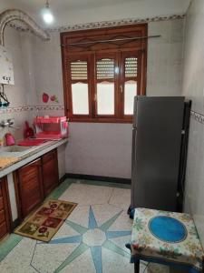 a kitchen with a sink and a refrigerator at sweet Atlas hollydays in Azrou +1 photo