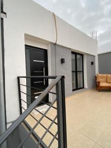 a balcony of a white building with a railing at Complejo Terranova in Aimogasta