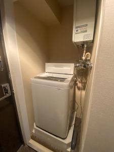 a bathroom with a toilet in a room at メープル桑園駅311 in Sapporo