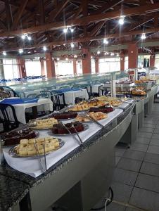 a buffet line with many plates of food at Pousada Fecep in Guaratuba