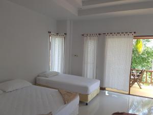 Postel nebo postele na pokoji v ubytování Diamond Beach Resort