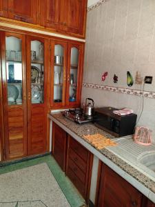 a kitchen with wooden cabinets and a counter top at sweet Atlas hollydays in Azrou