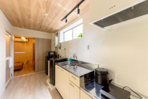 a small kitchen with a sink and a stove at Darin中洲北 2F in Fukuoka