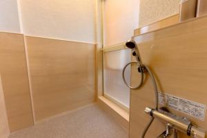 a shower in a bathroom with a door at Darin中洲北 2F in Fukuoka