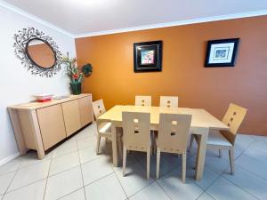 a dining room with a table and chairs at Jubilee Apartment 14 in South West Rocks
