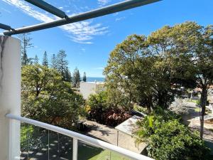 a view of the ocean from the balcony of a house at Jubilee Apartment 14 in South West Rocks