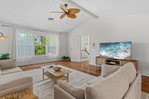 a living room with a couch and a ceiling fan at Seaside Rendezvous in Sanibel