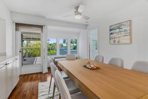 a kitchen and dining room with a wooden table and chairs at Seaside Rendezvous in Sanibel
