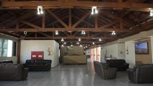 a lobby with couches and chairs in a building at Pousada Fecep in Guaratuba