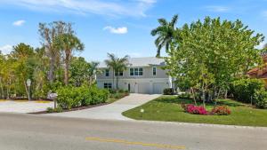 a large white house with a driveway at Seaside Rendezvous in Sanibel