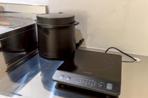 a black coffee maker sitting on a counter at Darin中洲北 2F in Fukuoka