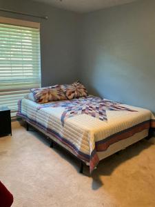 a bed in a bedroom with a window at Abundant life in Arlington