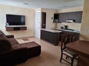a living room with a couch and a kitchen at Full Apartment Teotihuacan Centro in San Juan Teotihuacán +10 photos