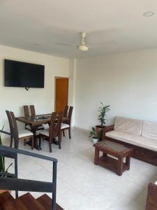 a living room with a couch and a table at Casa Sol & Descanso Tocaima in Tocaima +4 photos