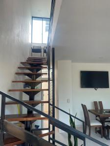 a group of stairs with chairs and a flat screen tv at Casa Sol & Descanso Tocaima in Tocaima