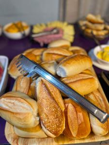 a plate of buns with a knife and fork at Hotel Brasilia in Aracaju