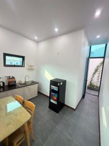 a kitchen and dining room with a table and a counter at De Paris Homestay in Cửa Lô