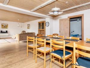 a dining room with a table and chairs at Lush holiday home in Thyholm in Thyholm