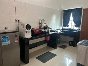 a kitchen with a counter with a appliance on it at FE Homestay in Tawau