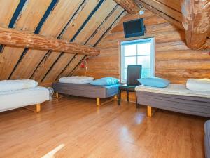 a room with three beds in a wooden cabin at Holiday home with pool in Ansager in Ansager +32 photos