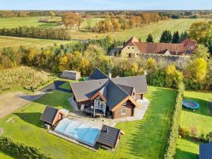 an aerial view of a house with a large yard at Holiday home with pool in Ansager in Ansager