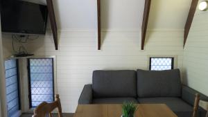 a living room with a couch and a table at Picnic Bay Chalet Unit 2 in Picnic Bay