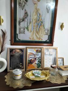 a table with framed pictures and a plate on it at Casa Bonita Davao in Davao City +12 photos