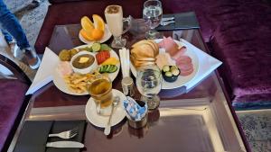 a table topped with plates of food and glasses of wine at Garden El Tahrir Downtown Hotel in Cairo
