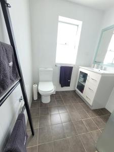 a bathroom with a toilet and a sink at Esplanade Bliss in Cronulla +22 photos