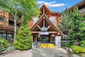 a building with a sign on the front of it at Central Alpine Condo in Whistler